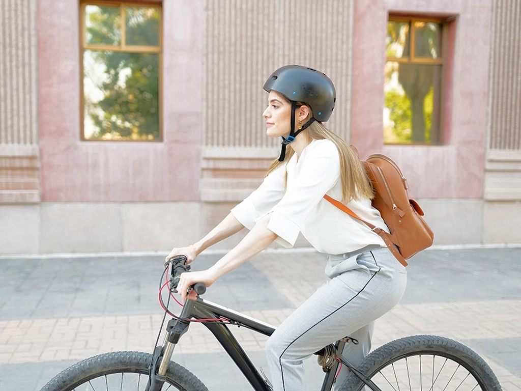Woman on a bike with backpack